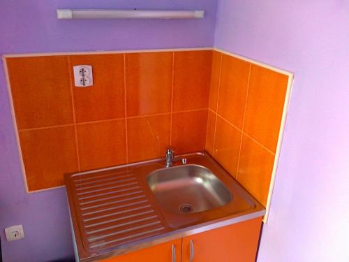 a bathroom with a sink in the corner of a room at Hostel M in Belgrade