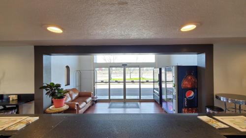 a living room with a couch and a table at Ramada by Wyndham Flagstaff East in Flagstaff