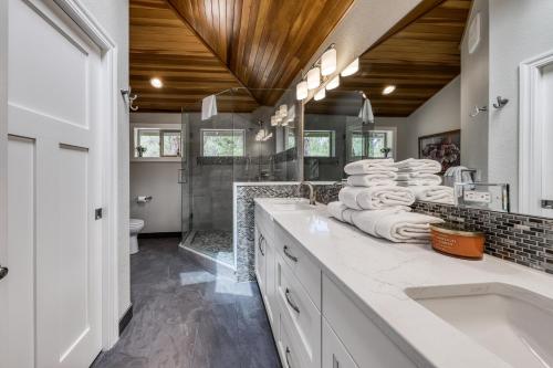 a bathroom with a sink and a toilet and a tub at Newberry Lane 10 | Discover Sunriver in Sunriver