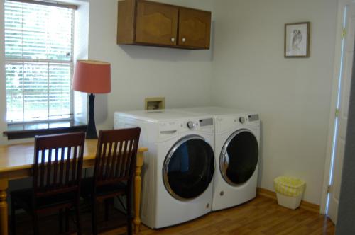 a washer and dryer in a room with a table at Lakehouse has Spectacular View plus Easy Access! in Rogers