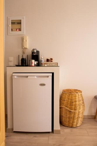 a small white refrigerator sitting next to a counter at Langi Apartments in Mesolongion