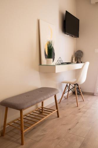 a room with a desk and a chair and a table at Langi Apartments in Mesolongion