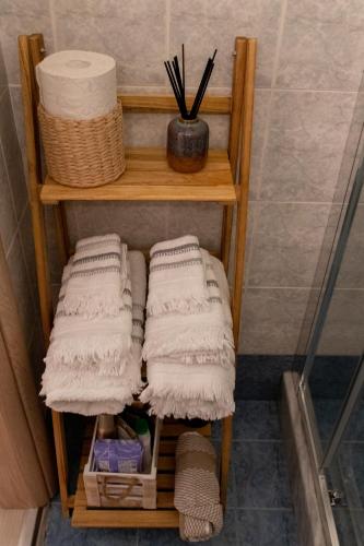 a group of towels on a shelf in a bathroom at Langi Apartments in Mesolongion