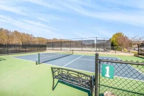 a tennis court with a bench on it at Birchwood: Bay View in Harbor Springs