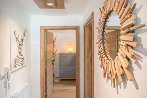 a mirror on the wall in a hallway at Mountain Base Fieberbrunn in Fieberbrunn