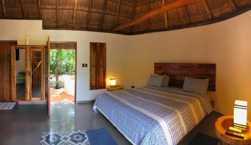 Cama ou camas em um quarto em Cenote San Ignacio