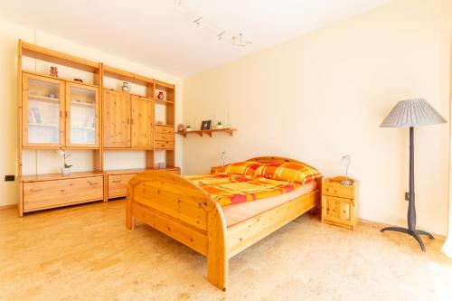 a bedroom with a bed and a lamp in it at Sunny Beach in Zánka