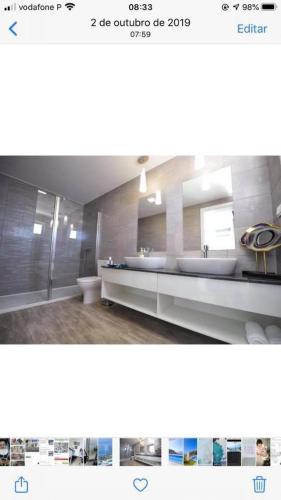 a bathroom with a sink and a toilet in it at Villa Atlantic Charm in Venda do Atalhinho