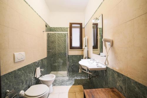 a bathroom with a toilet and a sink and a mirror at Tenuta Ferraro Gallipoli in Gallipoli