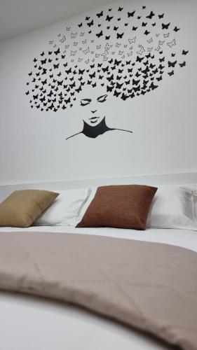 a head of a bed with birds flying over it at Villa Vittoria in Mesagne