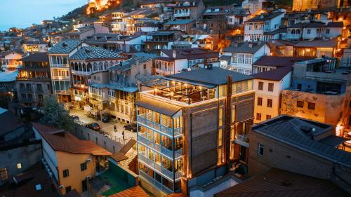 a building in the middle of a city at night at TbiliSee Hotel in Tbilisi City