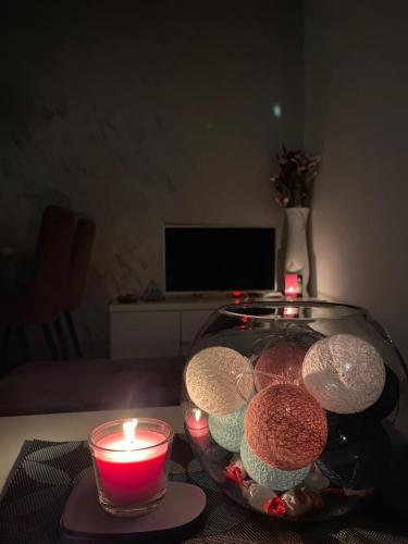 a bowl of cookies and candles on a table at VIP APARTMAN 2020 in Vrnjačka Banja