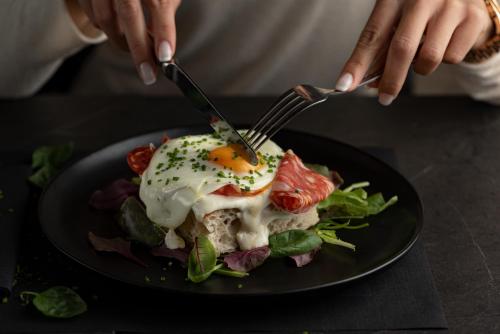 a plate of food with a fried egg on top at MiraMe Athens Boutique Hotel in Athens