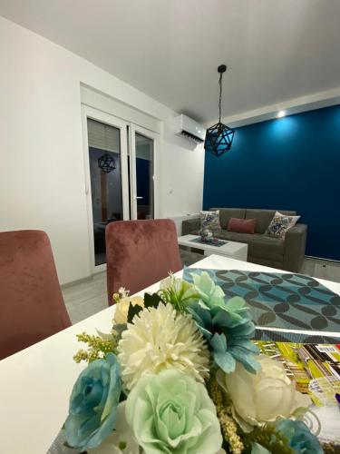 a table with a bouquet of flowers on it at VIP APARTMAN 2020 in Vrnjačka Banja
