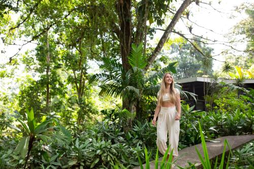 a woman is standing in the jungle at Chachagua Rainforest Hotel & Hot Springs in Fortuna