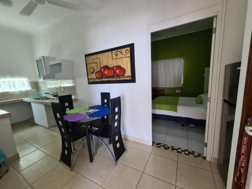 a kitchen with a table and chairs in a room at Casa Mia in Puerto Escondido
