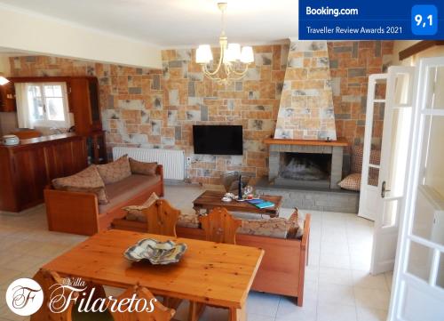 a living room with a brick wall at Villa Filaretos in Vavkerí