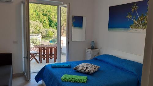 a bedroom with a blue bed and a sliding glass door at SANTACROCE&S.ANTONINO HOUSE in Termini