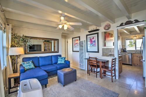 a living room with a blue couch and a table at San Diego Hub with Bay Views - 1 Block to Beach! in San Diego