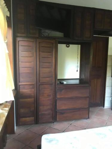 a kitchen with wooden cabinets and a counter top at FLOR DE PARAISO BUNGALOWS in Montezuma