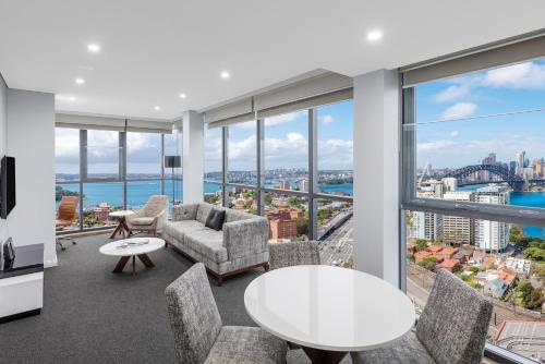a living room with a view of the city at Meriton Suites North Sydney in Sydney