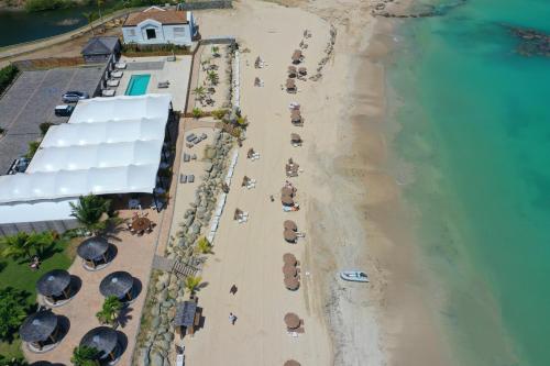 an overhead view of a beach with umbrellas and the ocean at Le Domaine Anse Marcel Beach Resort in Anse Marcel 