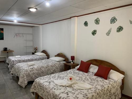 a hotel room with two beds in a room at Globi lodge #2 in Monteverde Costa Rica