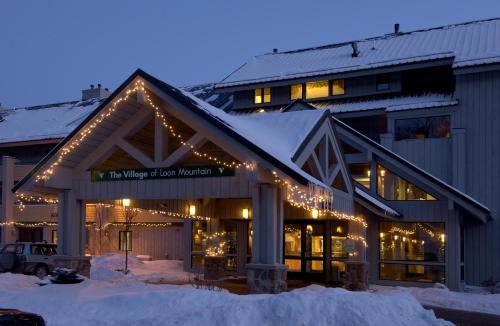 a building with christmas lights on it in the snow at Village of Loon Mountain in Lincoln