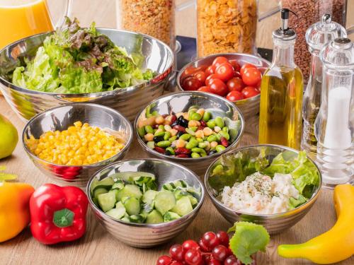 a table topped with bowls of different types of vegetables at Hotel Wing International Sapporo Susukino in Sapporo