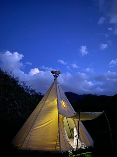 a lit up tent with the sky in the background at @Logovo_Sovi in Almaty