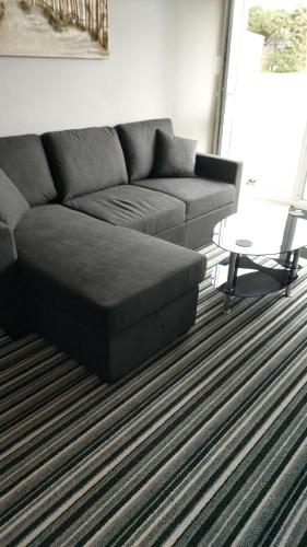 a living room with a couch and a coffee table at Park view chalet in Hemsby