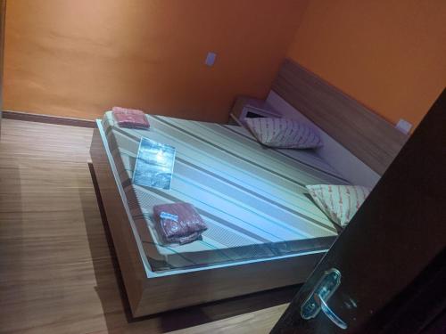 a bed in a room with a glass case at Hotel Santos in Santos