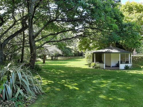 a gazebo in the middle of a green yard at Wainono Homestead in Waimate