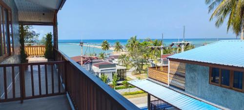 a balcony of a house with a view of the ocean at Le Grand Bleu Hotel in Wok Tum