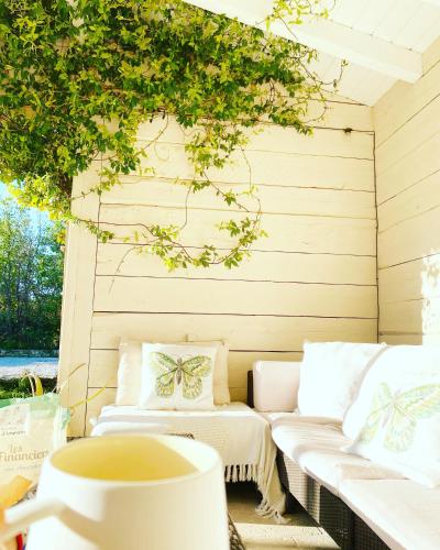 a patio with two white couches and a cup of coffee at villa Luberon in Saint-Saturnin-les-Apt
