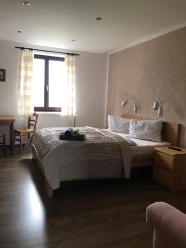 a bedroom with a large bed and a window at Penzion Marie - Žumberk in Žumberk