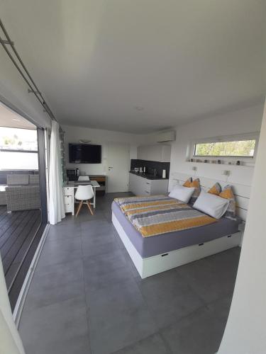 a bedroom with a large bed and a desk at Appartement Hareter in Neusiedl am See