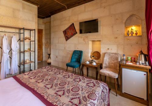 a bedroom with a bed and a table and chairs at Lord of Cappadocia Hotel in Goreme