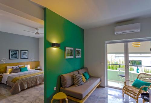 a bedroom with a bed and a green wall at Koukounari Living Spaces in Preveza