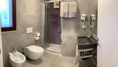 a bathroom with a shower and a toilet and a sink at AI QUATTRO SOLI 