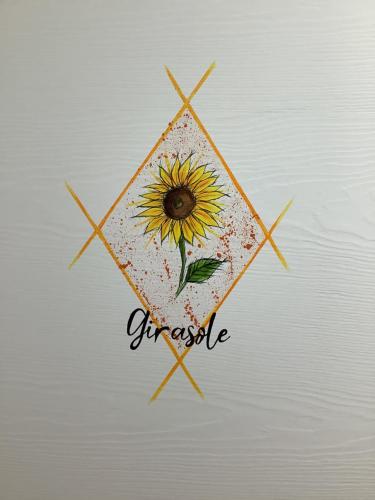 a drawing of a sunflower in a diamond with the word craze at AI QUATTRO SOLI in Privano