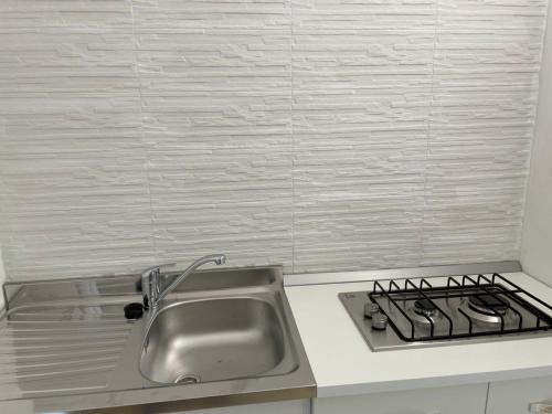 a kitchen with a sink and a stove at Casa di Clara in Rapallo