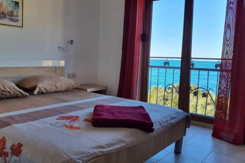 a bedroom with a bed with a view of the ocean at Peaceful Sea Residence in Bigovo