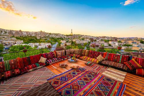 a living room with couches and a table on a balcony at Lord of Cappadocia Hotel in Goreme