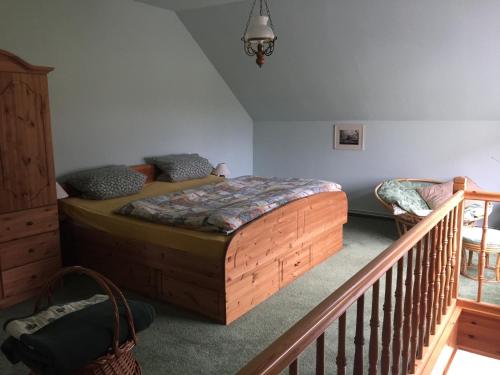 a bedroom with a bed in a room with a staircase at Parkblick Grüner Salon in Satow