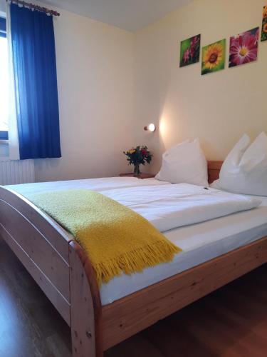 a bedroom with a large bed with a blue curtain at Ferienwohnung Ronacher in Abtenau