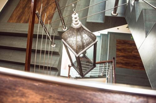 aendant light hanging from a stair case with a staircase at Hotel Mieszko in Rzeszów