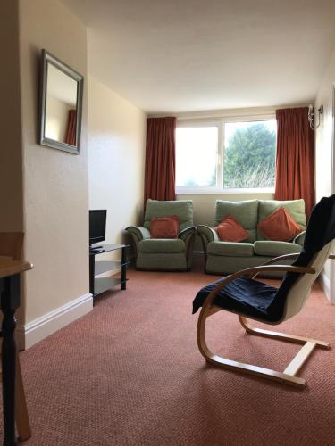 a living room with a couch and a chair at Brialene Holiday Flats in Scarborough