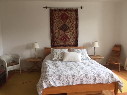 a bedroom with a bed with a quilt on it at Le Couvent in Saint-Just-sur-Viaur