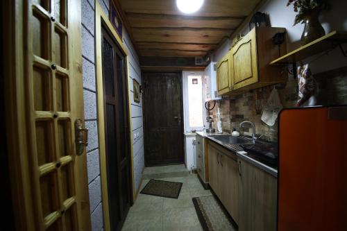 a small kitchen with a door open to a hallway at Alashkert Guesthouse ,Ալաշկերտ Հյուրատուն in Gyumri